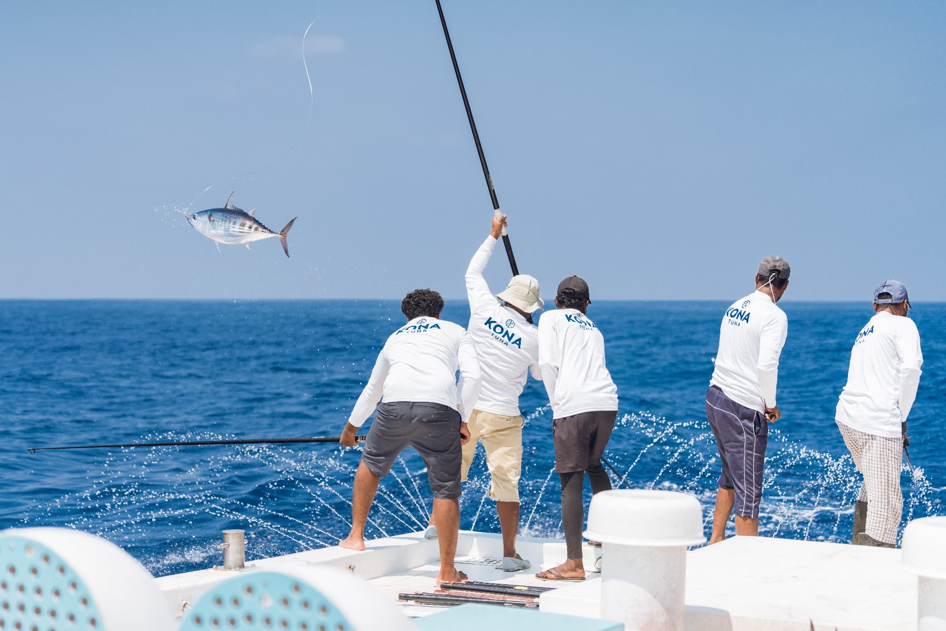 A tuna arcing through the air as the crew lands it